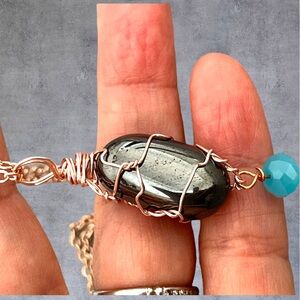 Rose gold plated wire wrapped oval onyx pendant